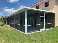 Pflugerville screen room built with clean aluminum lines and a seamless tie‑in to the home’s existing roof.