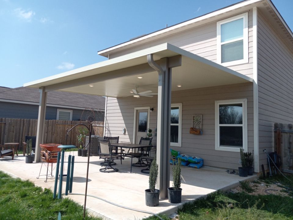 Attached patio cover with extended shade over pool deck in Hunter, TX