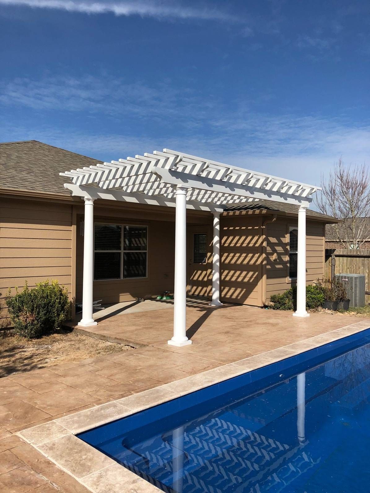 Aluminum pergola installed beside a garden pathway for partial shade in Spicewood.