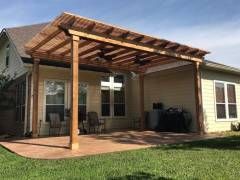 Rustic natural‑finish cedar pergola in Helotes.