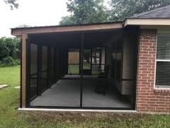 Buda screen room featuring a simple attached roof and open‑view screen panels for a natural, airy feel.