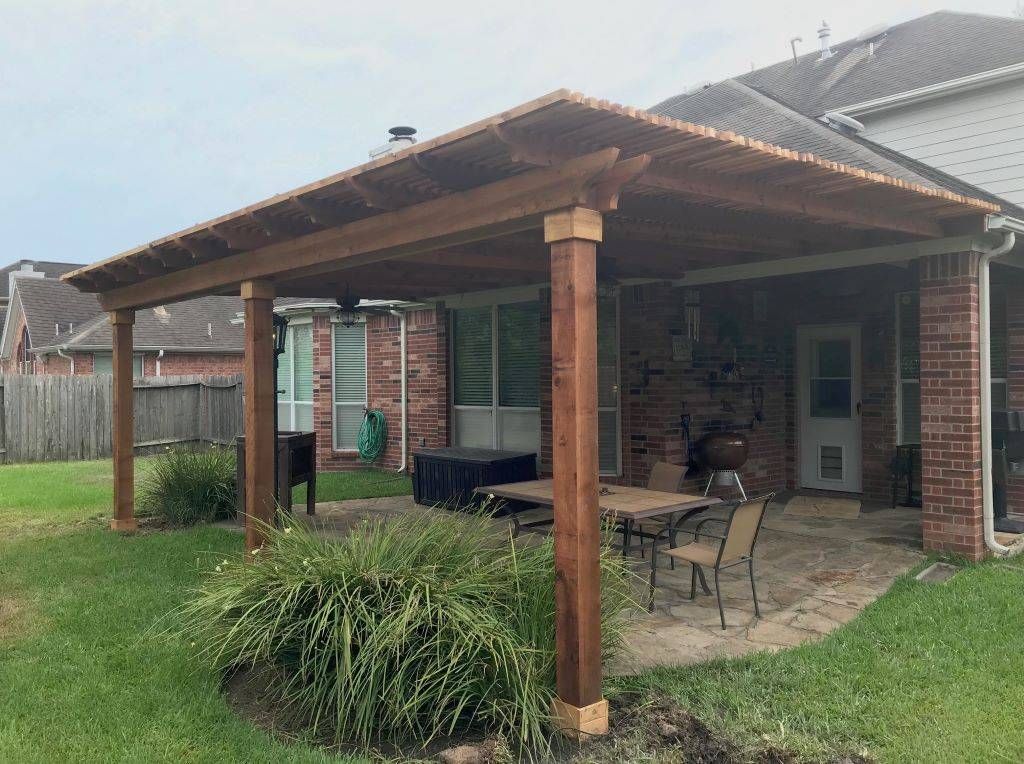 Dark‑stained cedar pergola in Round Rock.