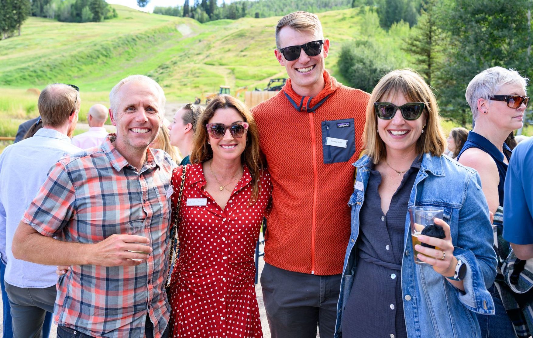 Attendees enjoying a CORE-sponsored community sustainability event, surrounded by interactive exhibits and solar-powered demonstrations in Aspen.