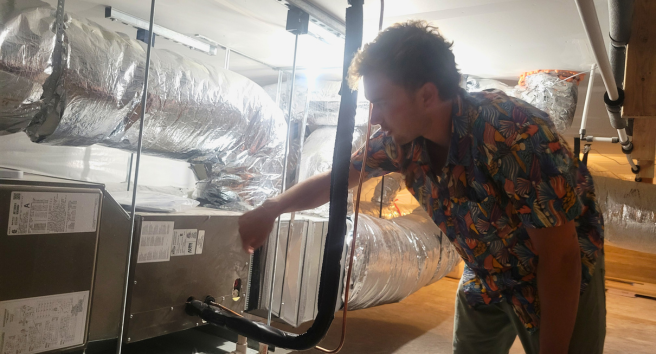 CORE staff member conducting a home energy assessment in Aspen, demonstrating their hands-on approach to climate solutions.