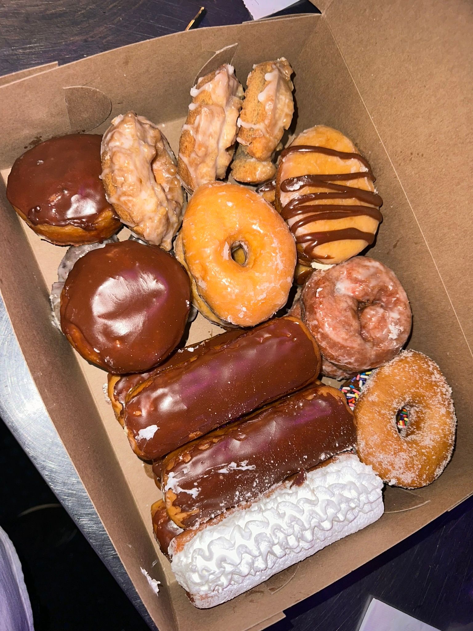 a box filled with a variety of donuts and pastries .