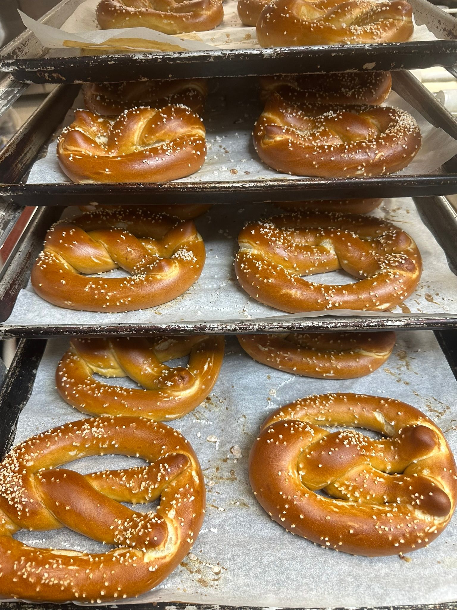 a bunch of pretzels are sitting on top of each other on a tray .