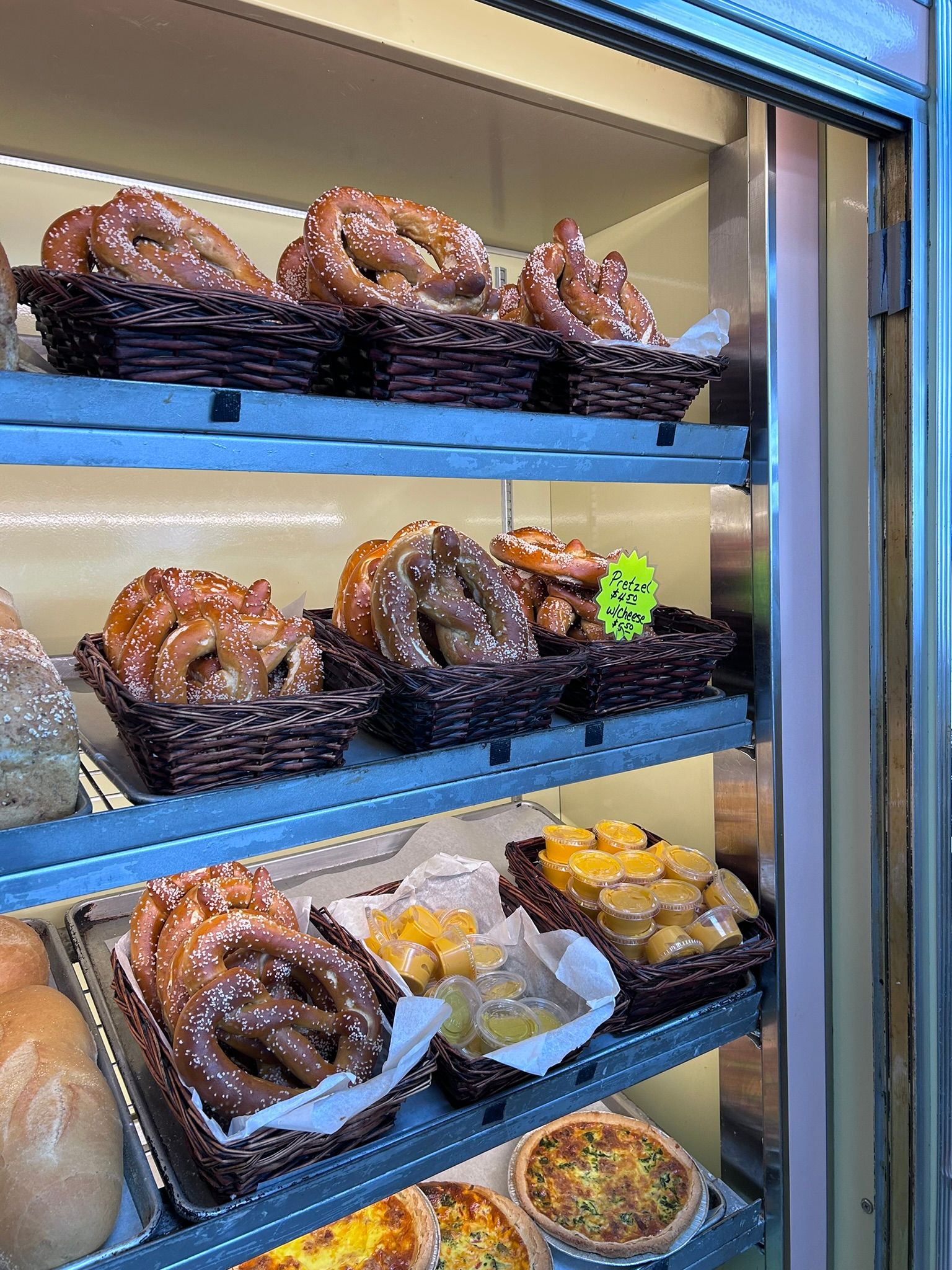 a bakery display case filled with pretzels and other pastries .