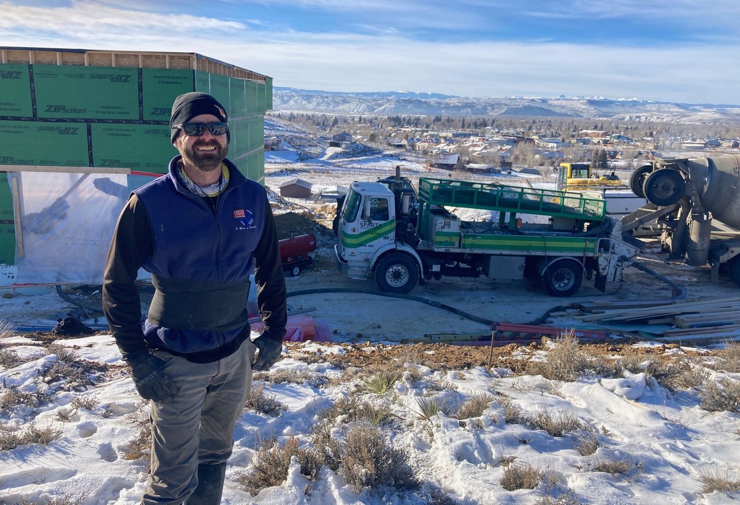 jay hunt stands in front of green and white sparata line pump truck