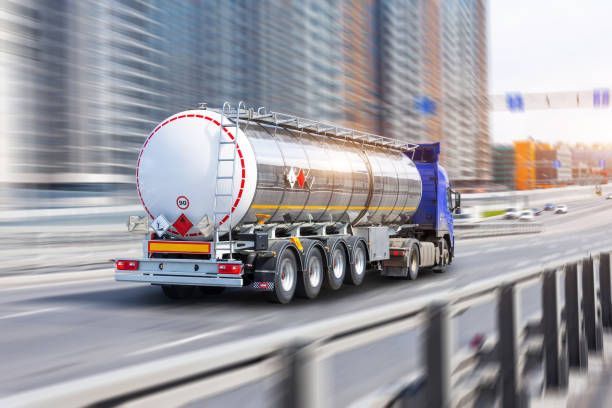 A tanker truck is driving down a highway.