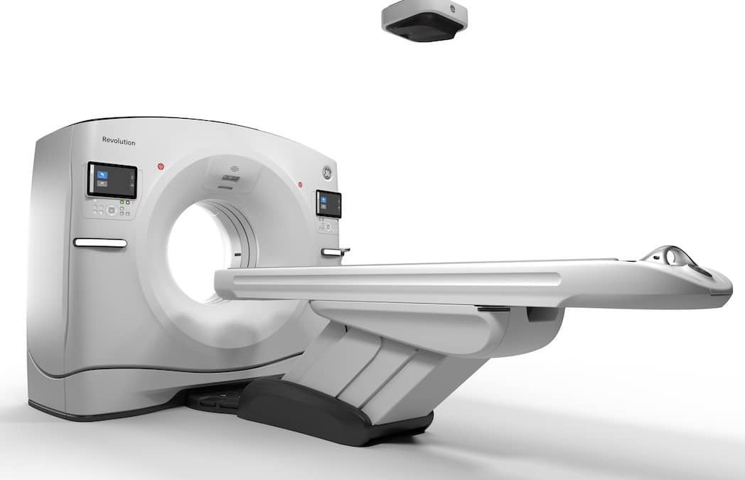 A ct scan machine is sitting on a white surface.