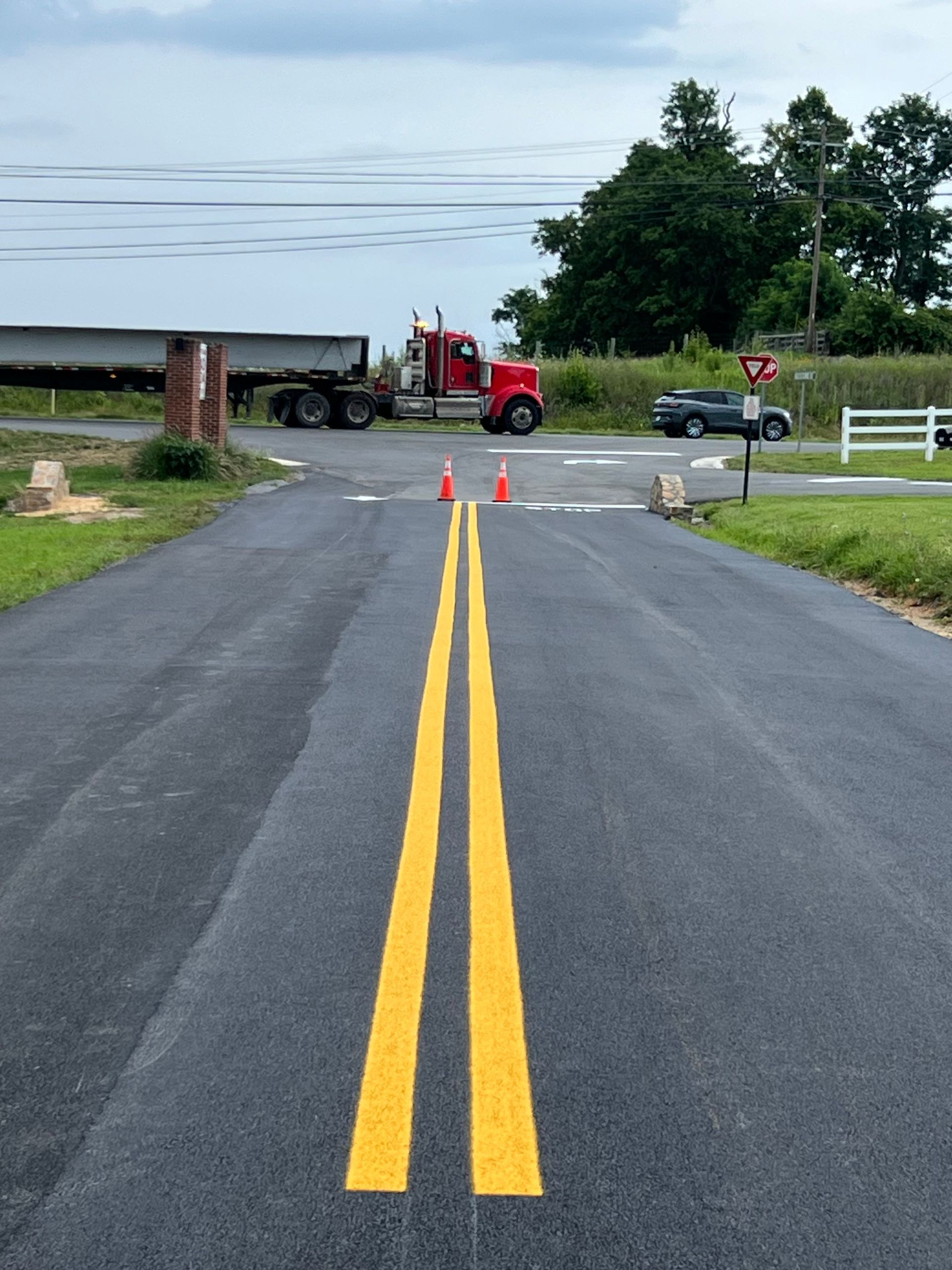 Image of a company that does parking lot striping near me. You can see a double yellow line that was freshly painted.