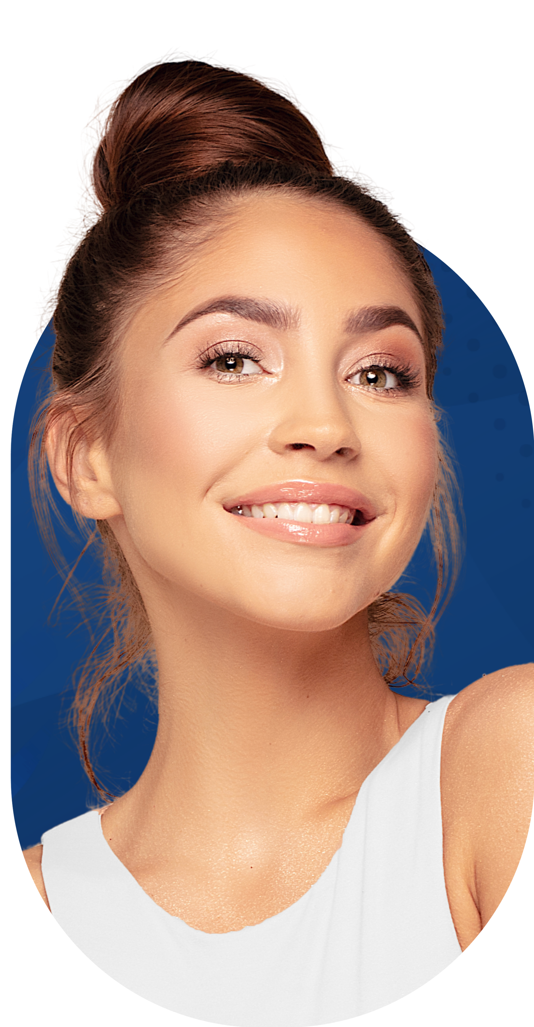 Woman with a bun smiles, wearing a white top. Shimmering makeup and light background.