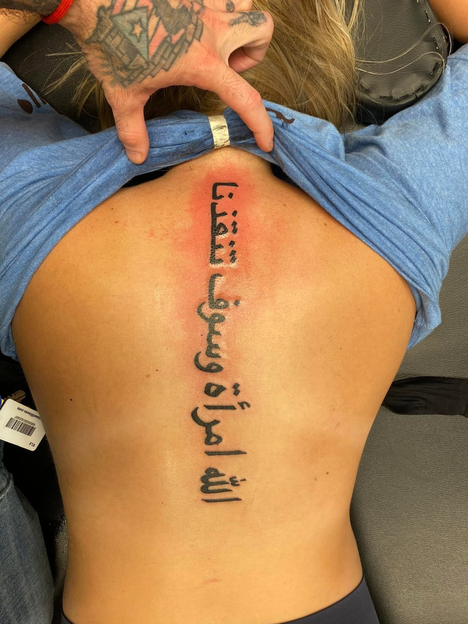 Tattoo by Eric Estrada at The Widow's Son Tattoo Co. in Gilbertsville, PA — script lettering across a lower back