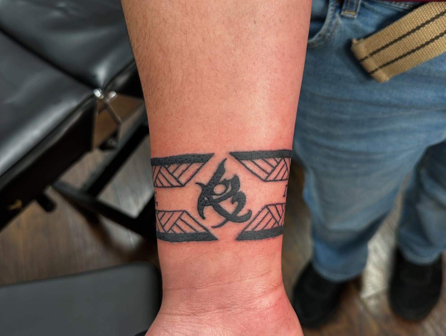 Tattoo by Eric Estrada at The Widow's Son Tattoo Co. in Gilbertsville, PA — a solid blackwork armband with a woven pattern