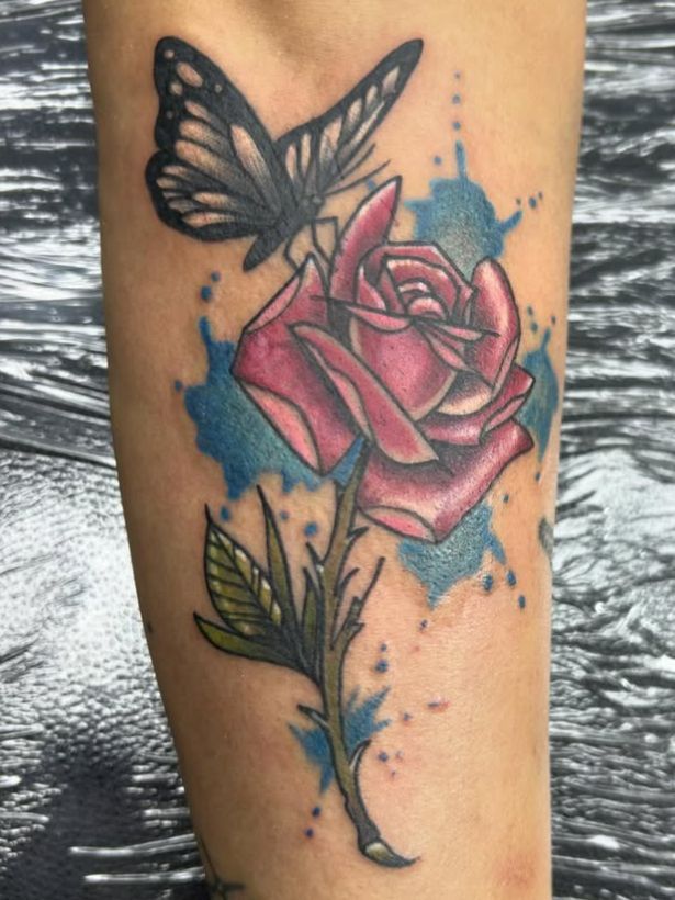 Tattoo by Tom Kelly at The Widow's Son Tattoo Co. in Gilbertsville, PA — a rose in colour with leaves