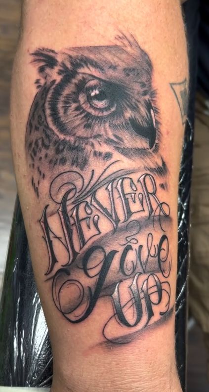 Tattoo by Tom Kelly at The Widow's Son Tattoo Co. in Gilbertsville, PA — a wolf with Never Give Up lettering