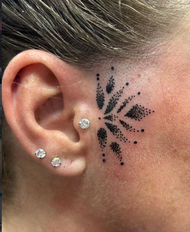 Multiple ear piercings at The Widow's Son Tattoo Co.