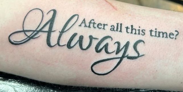 Tattoo by Tom Kelly at The Widow's Son Tattoo Co. in Gilbertsville, PA — flowing script lettering on a forearm