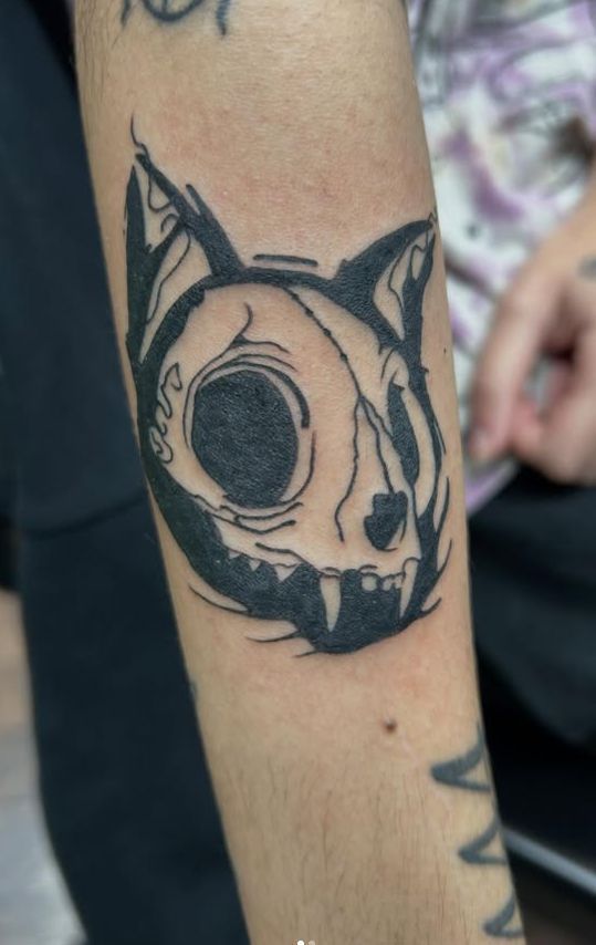 Tattoo by Tom Kelly at The Widow's Son Tattoo Co. in Gilbertsville, PA — a cat skull in heavy black outline