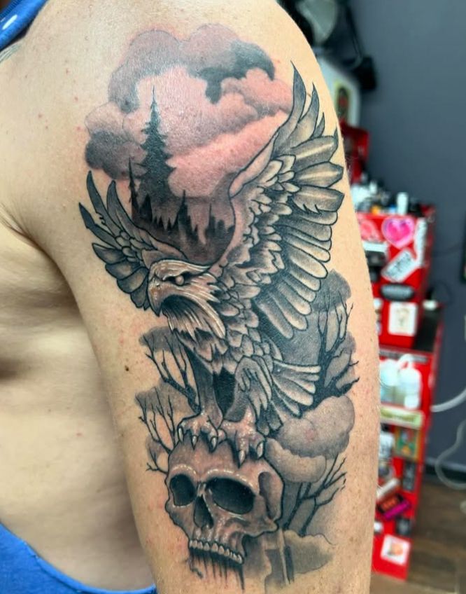 Tattoo by Tom Kelly at The Widow's Son Tattoo Co. in Gilbertsville, PA — a black and grey dragon on an arm