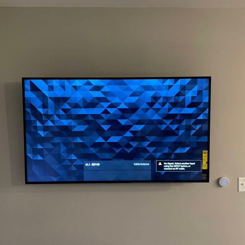 A flat screen tv is hanging on a wall.