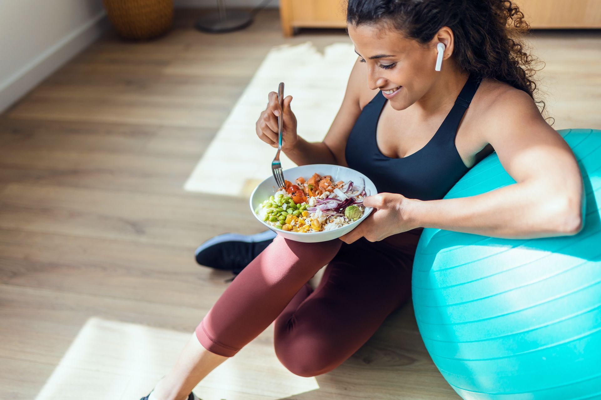 A woman is eating a salad.