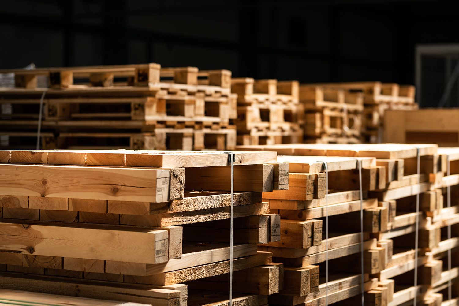 Freshly built wooden pallets in storage highlighting an experienced pallets and skids provider.