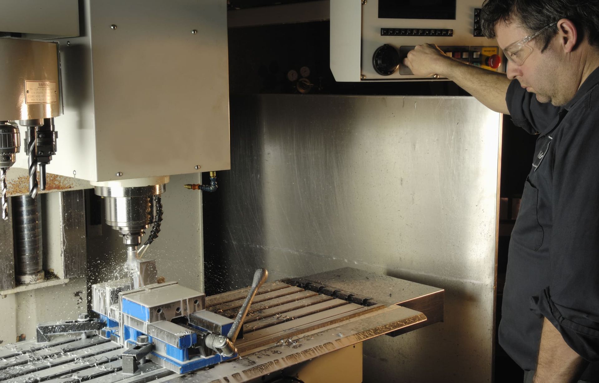 A man is working on a machine in a factory