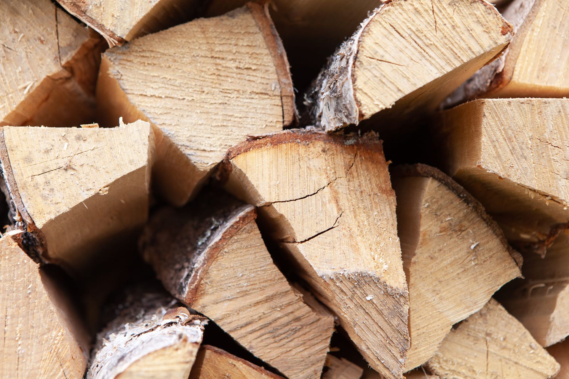 A pile of chopped wood is stacked on top of each other.