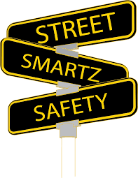 Black and yellow street signs stacked vertically reading “Street Smartz Safety”