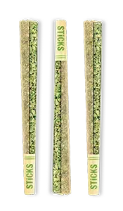 Three slim green snack sticks in clear packaging labeled “STICKS” on white background