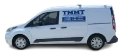 A white van with the word tmmt on the side.