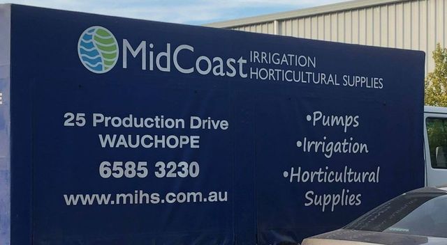 A midcoast irrigation horticultural supplies truck is parked next to a car — Midcoast Irrigation & Horticultural Supplies In Wauchope, NSW