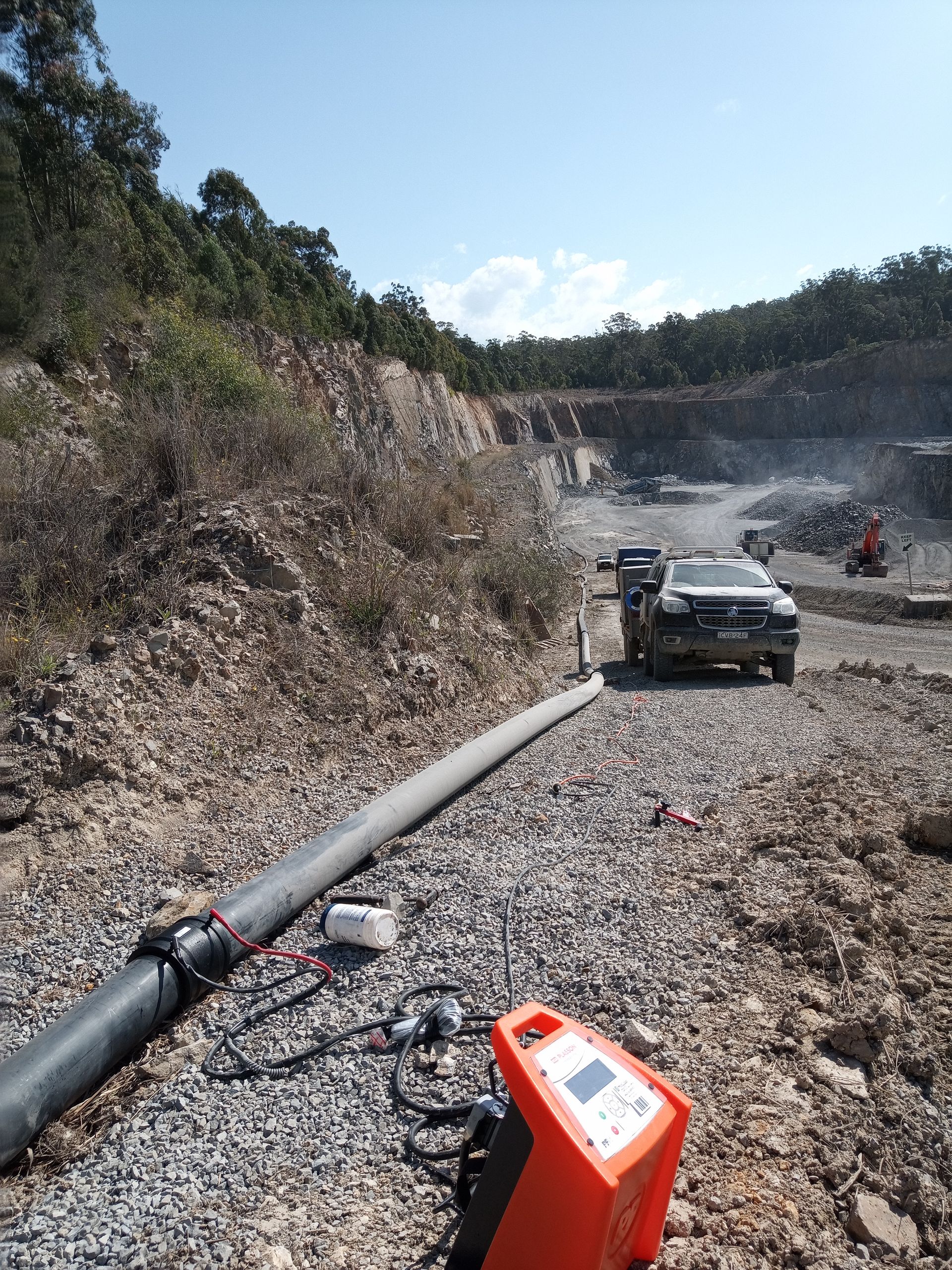 An orange device is sitting on the ground next to a pipe. — Midcoast Irrigation & Horticultural Supplies In Wauchope, NSW