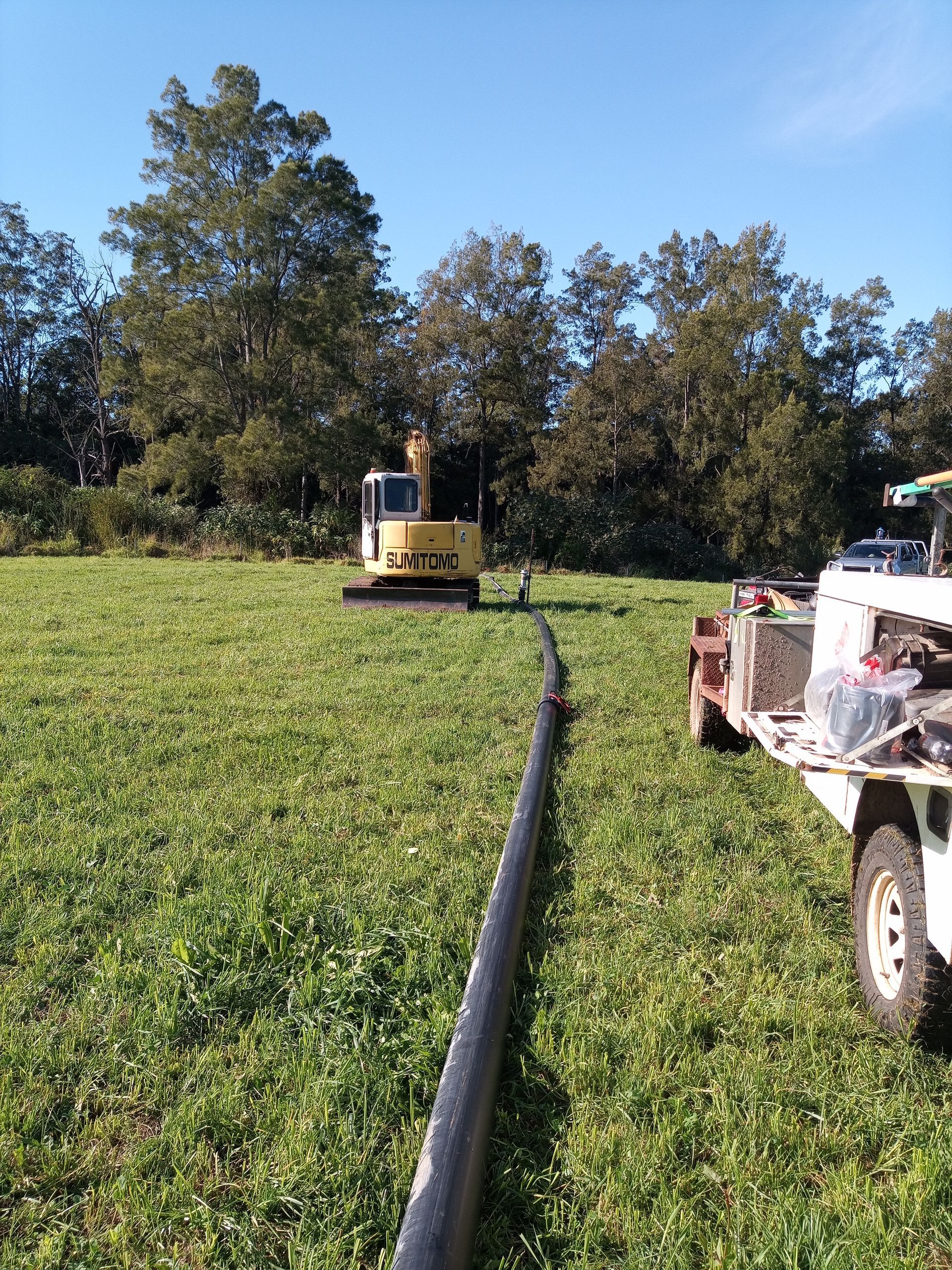 A Large Pipe Is Sitting In The Middle Of A Grassy Field — Midcoast Irrigation & Horticultural Supplies In Wauchope, NSW