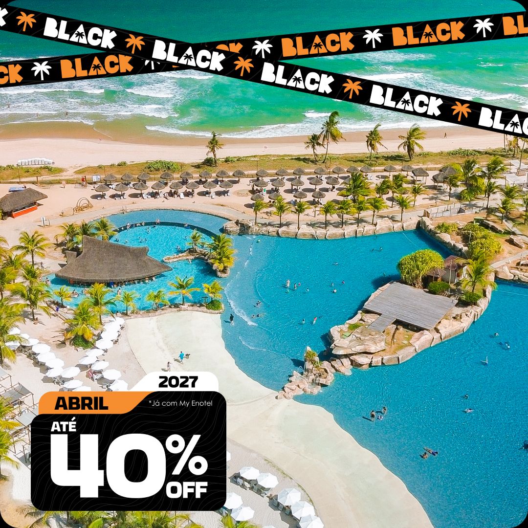 Vista aérea ampla das piscinas do resort Enotel, cercadas por coqueiros e áreas de lazer, com o mar verde-esmeralda de Porto de Galinhas ao fundo. A imagem contém o selo da promoção My Black com até 40% de desconto para reservas em abril de 2027