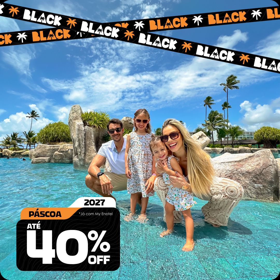 Vista aérea ampla das piscinas do resort Enotel, cercadas por coqueiros e áreas de lazer, com o mar verde-esmeralda de Porto de Galinhas ao fundo. A imagem contém o selo da promoção My Black com até 40% de desconto para reservas em abril de 2027