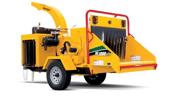 A yellow chipper is on a trailer on a white background.