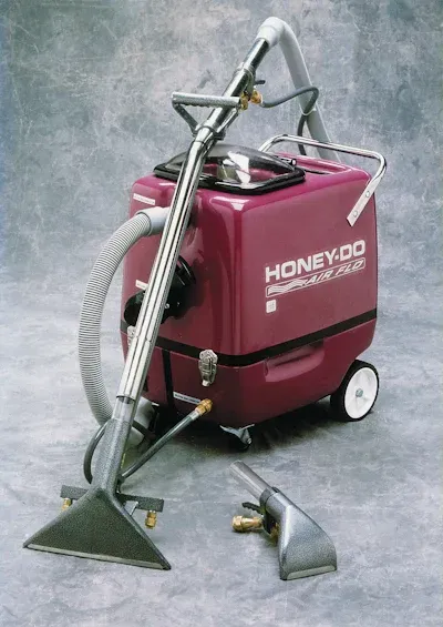 A purple vacuum cleaner that says honeydo on it