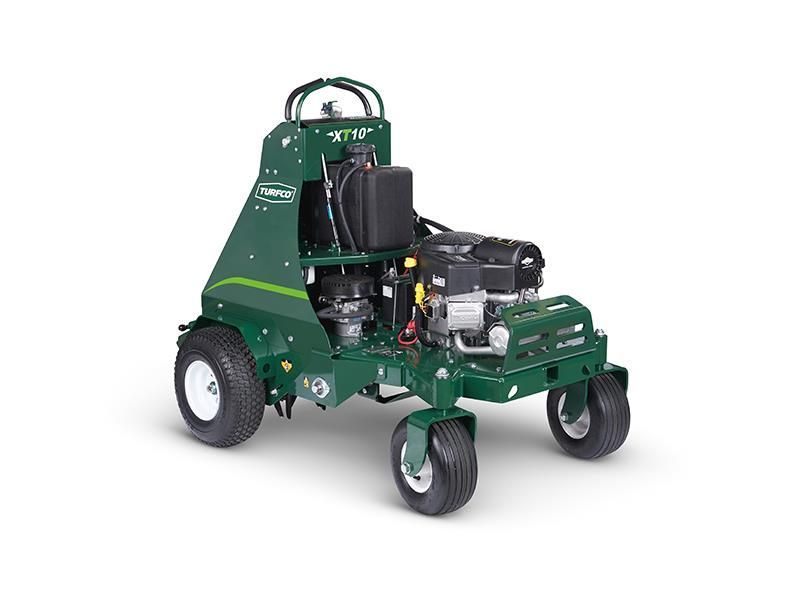 A green lawn mower is sitting on a white surface.