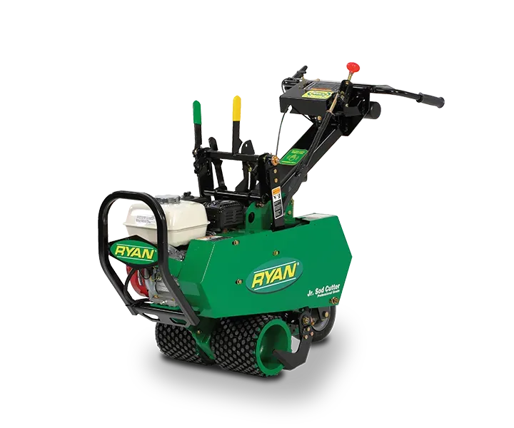 A green lawn mower is sitting on a white surface.