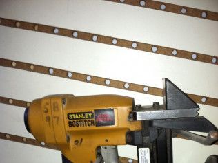 A stanley bostitch stapler is sitting on a white surface.