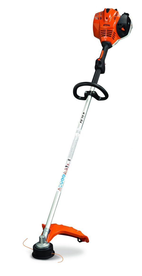A stihl trimmer is sitting on a white surface.