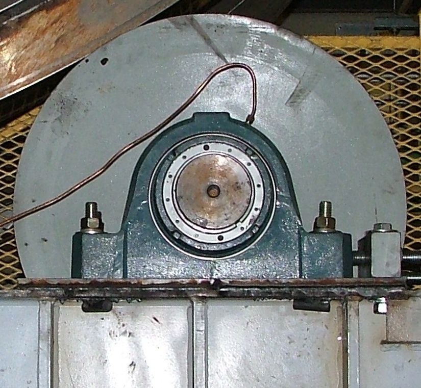 A close up of a machine with a copper wire coming out of it