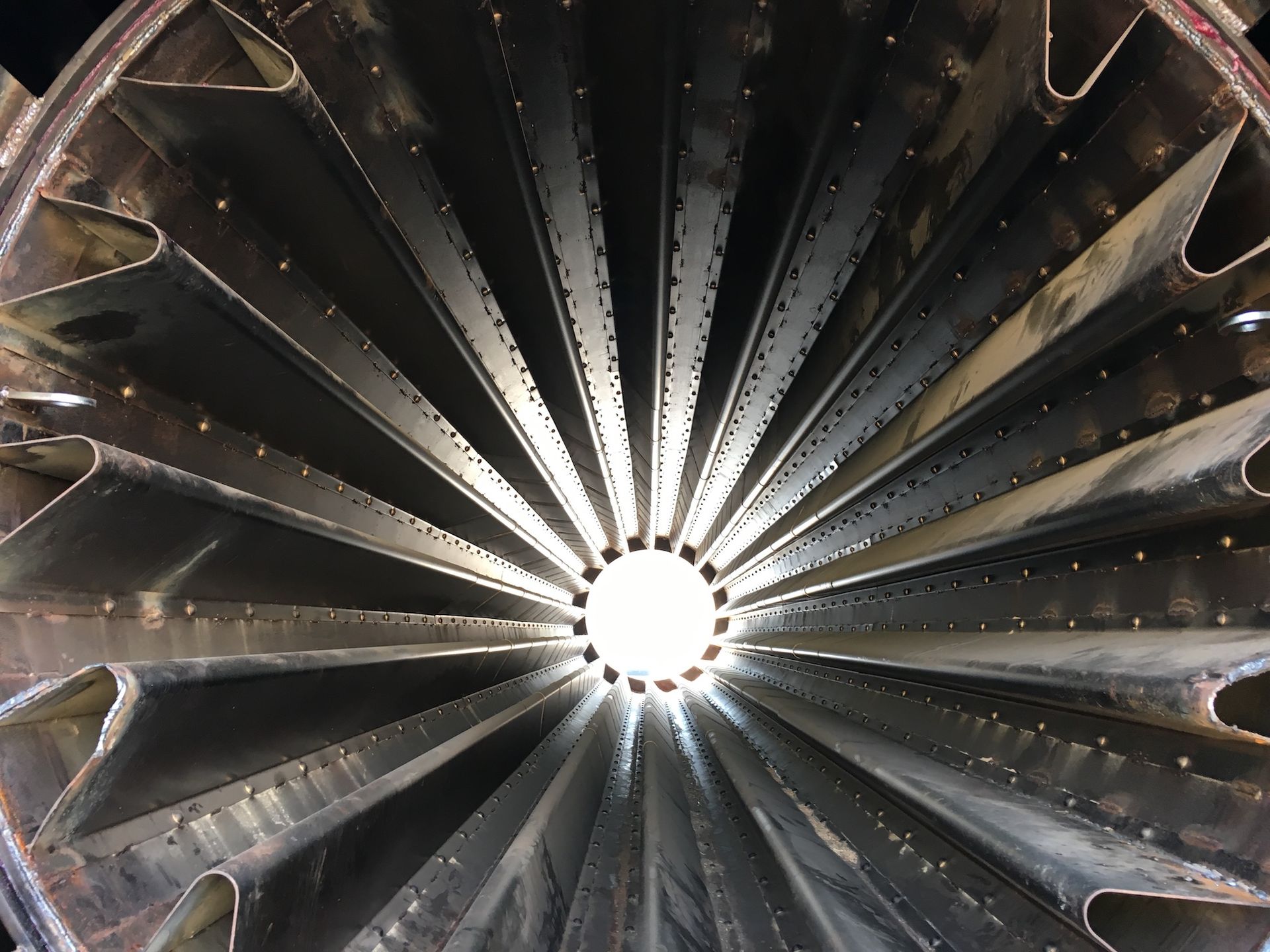 A close up of a metal structure with a light coming out of the center