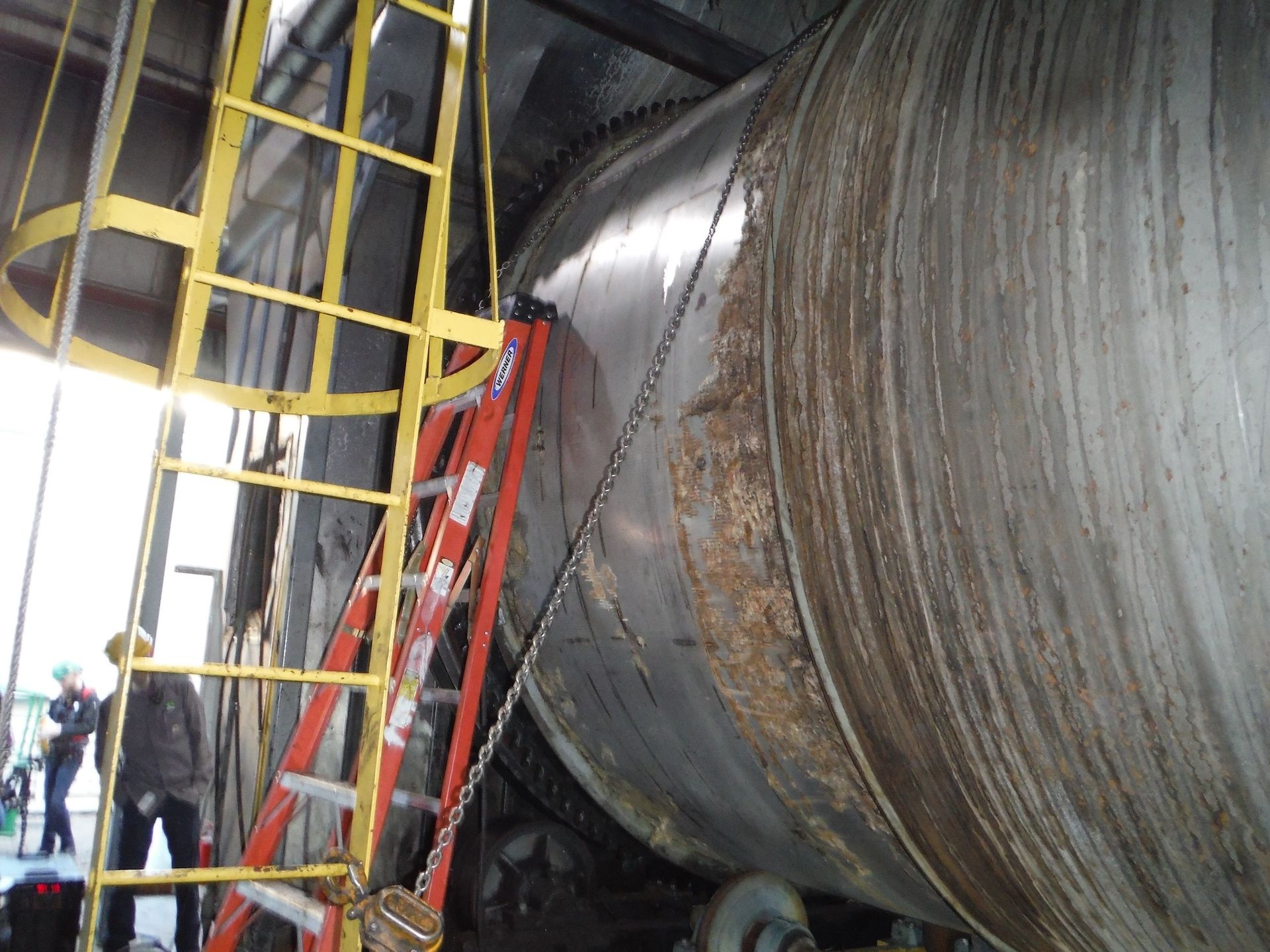 A ladder is attached to a large metal object