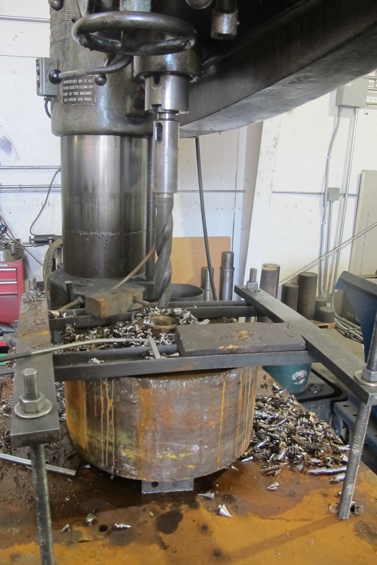 A machine is cutting a piece of metal on a table.