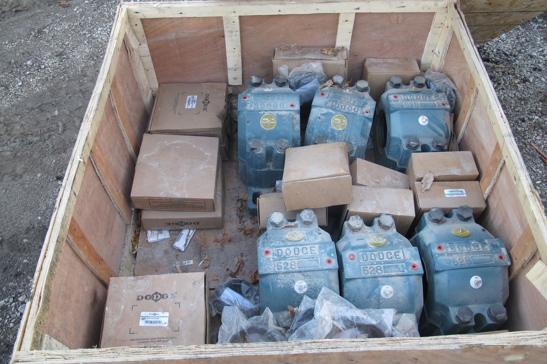 A wooden box filled with a bunch of boxes and pieces of metal