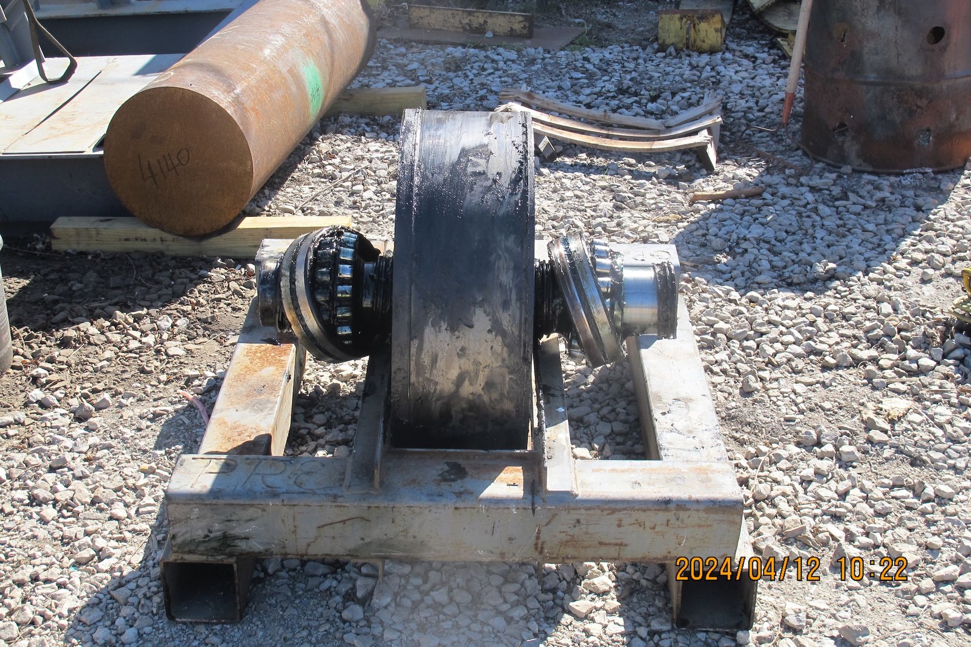 A piece of metal sitting on top of a gravel ground