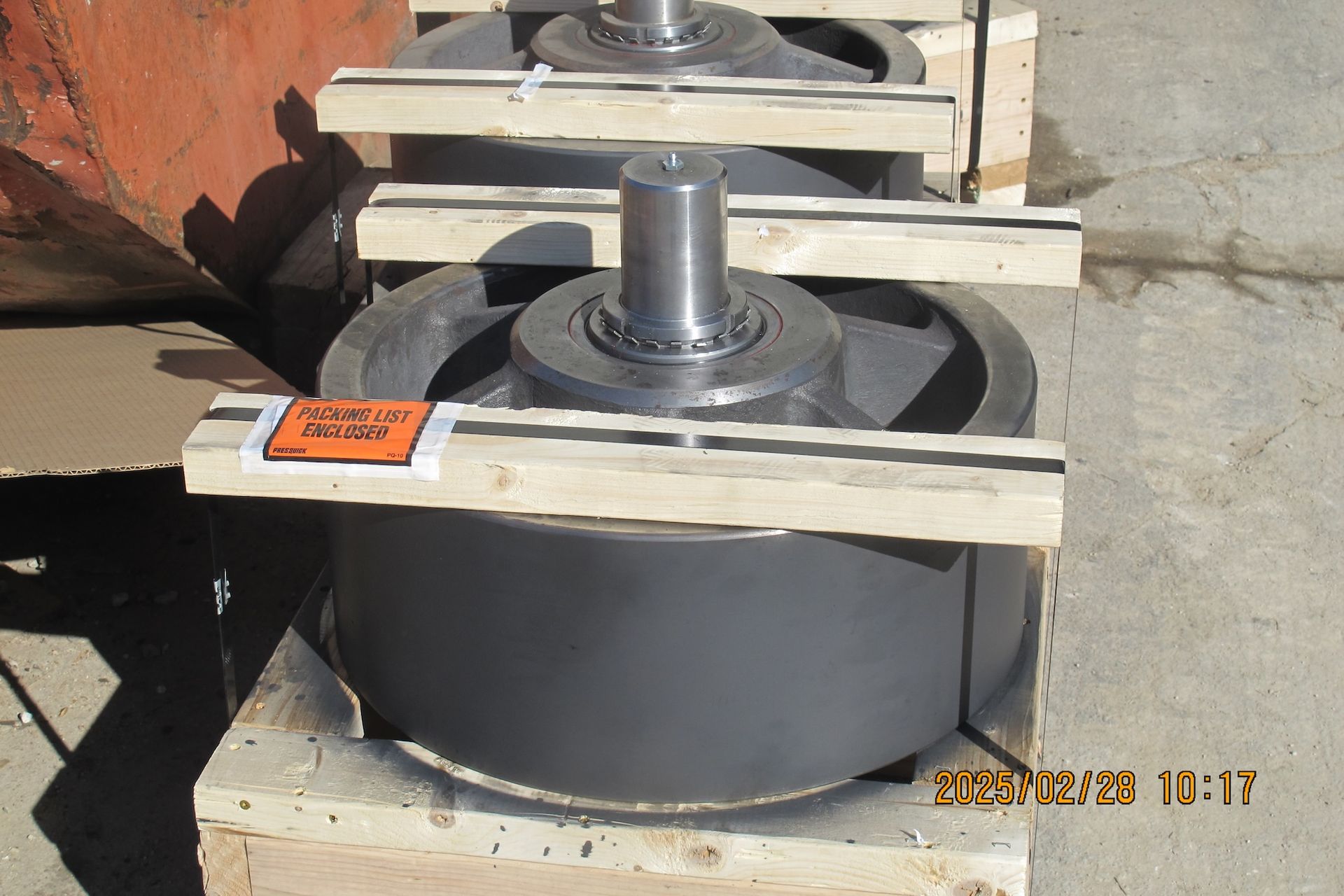 A bunch of wheels are stacked on top of each other on a wooden pallet